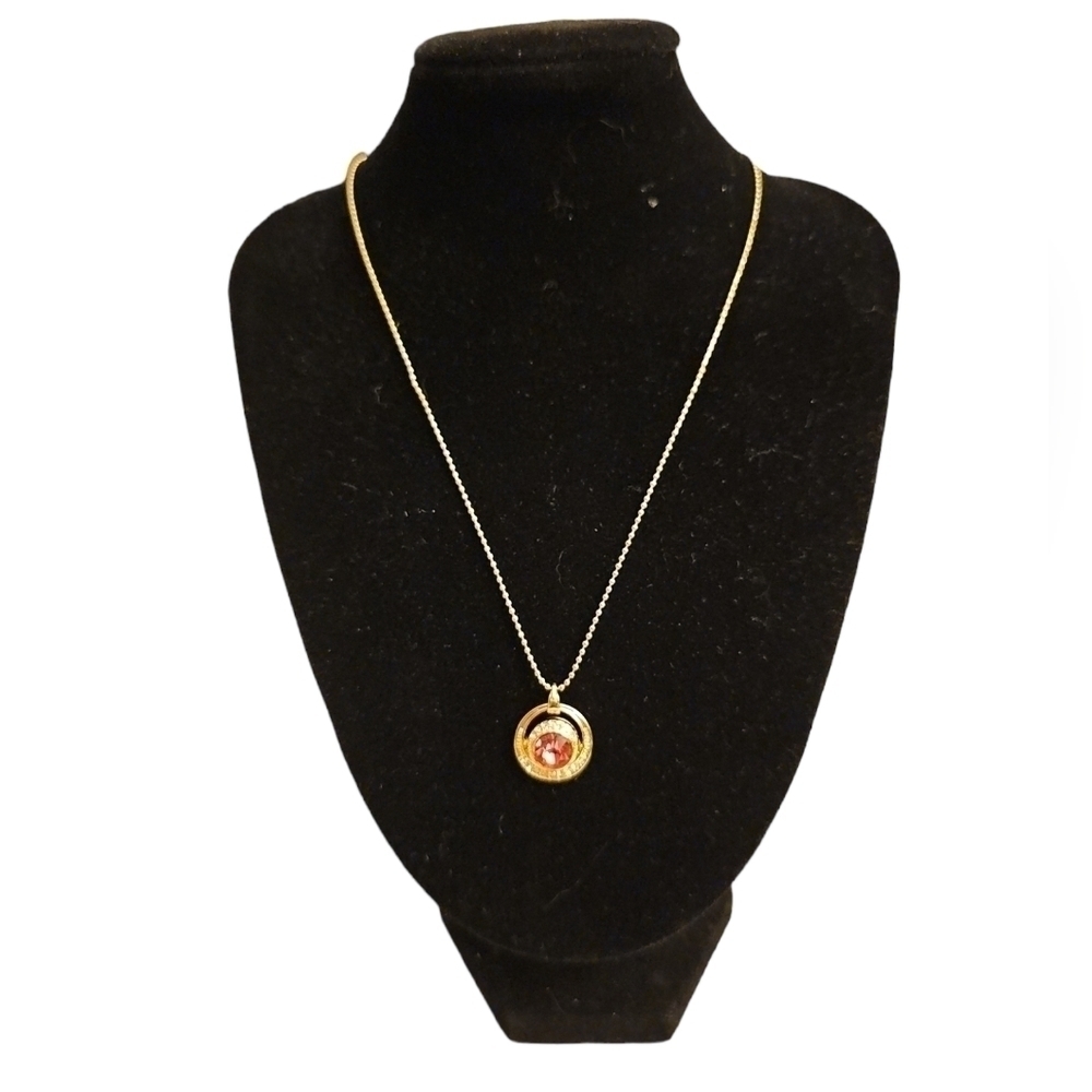 NWT Calvin Klein gold tone necklace with a ruby red cubic zirconia pendant